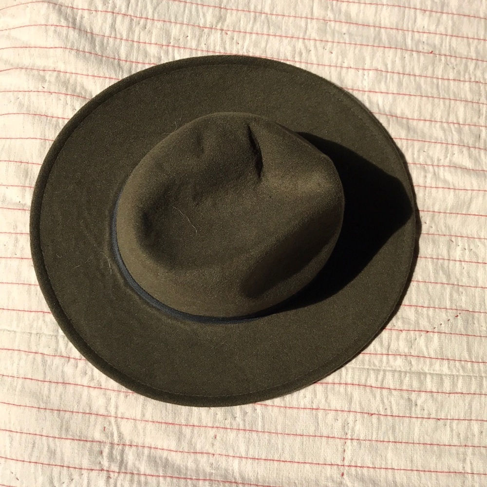 Green structured hat with black ribbon detailing